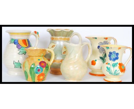 A selection of mid 20th Century hand painted ceramic jugs to include a burleigh ware jug having a fanned rim with green and b