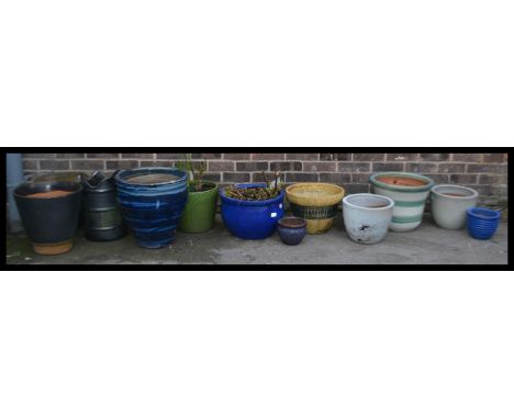 A collection of vintage large stone garden planters each of varying colours sizes and forms.