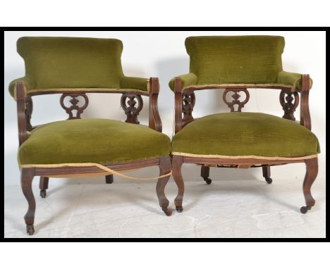 A pair of early 20th Century Edwardian&nbsp;mahogany tub shaped chair, upholstered in green velour fabric, raised on turned l