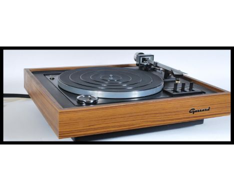 A vintage retro 20th Century teak cased record player having a Garrard 86SB turntable deck with smokey acrylic lid. Measures 