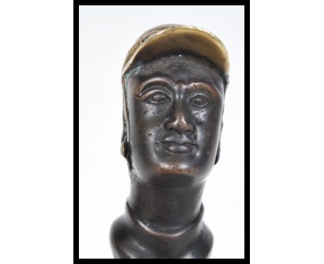 An early 20th Century bronze corkscrew in the form of a horse jockey in a riding hat. Measures 16 cm long.