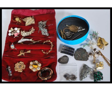 A good group of vintage costume jewellery to include vintage belt buckles, rhinestone spray brooches, niello / enamel example