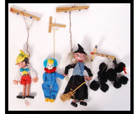A collection of 4x original vintage Pelham Puppets string hand puppet characters to include Pinocchio, Poodle, Witch and Clow
