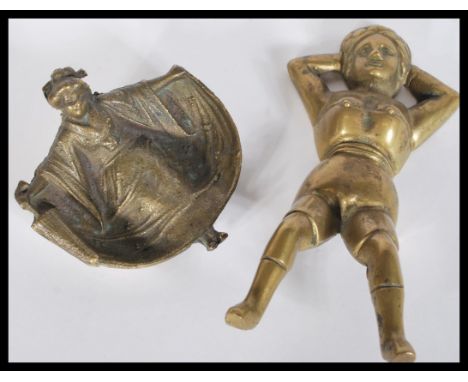 Two items of 19th Century Victorian erotica to include a wall mounted brass figurine of a partially dressed lady and a bronze