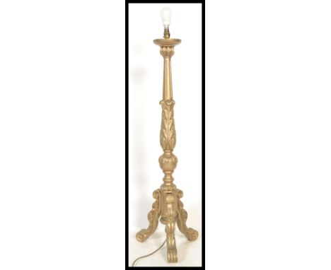 An 18th century style giltwood standard lamp, 20th century, the stopped fluted column with acanthus leaf ring on three scroll