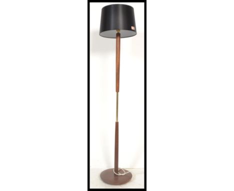 A vintage retro 20th century teak and brass column standard lamp raised on a circular base. Measures 140cm tall.