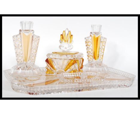 An early 20th Century Art Deco cut glass dressing table set with clear glass and amber glass, consisting of a tray, trinket b