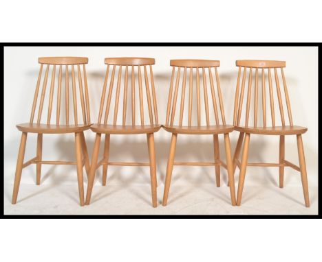 A set of four vintage retro 20th century Ercol style beech and elm Windsor dining chairs having stick backs with shaped back 