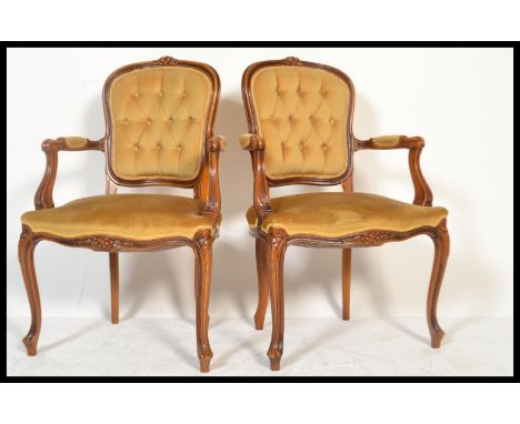 A good pair of French fauteuil / armchairs in mahogany having reeded, carved legs and shaped apron with carved elbow rests an