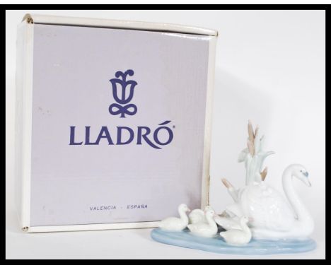 A Lladro ceramic figurine entitled Follow Me depicting swans 05722. Complete in original box. Measures 12 cm high.