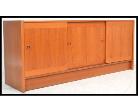 A vintage 20th Century Danish teak wood sideboard / credenza by Clausen and Sons. Central sliding doors flanked by a further 