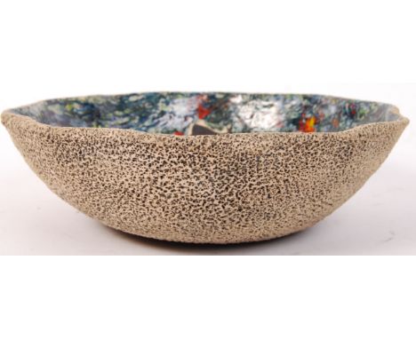 A 20th century studio art pottery large bowl with heavily textured exterior and mottled green , blue and red glazes with hunt