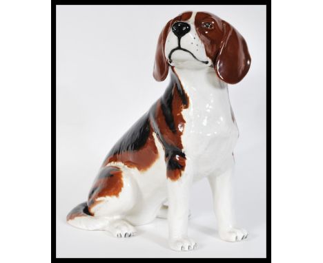 A vintage 20th Century ceramic fireside Beswick model of a beagle dog in a seated position, model number 2300. 33cm high 26cm