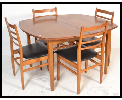 A vintage retro 20th Century teak extending dining table along with a set of four black vinyl dining chairs having ladder bac