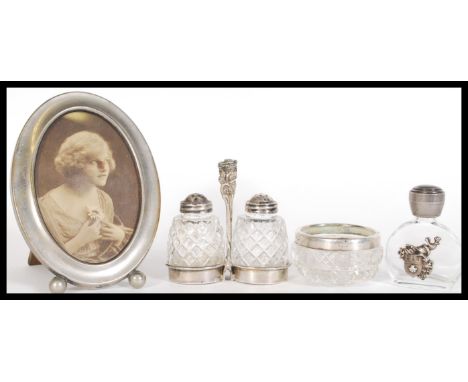 A group of early 20th Century silver white metal cruets and condiments along with a silver plated photograph easel frame of o