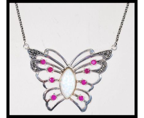 A sterling silver Cz and central paneled opal pendant necklace in the form of a butterfly. Weighs 13 grams. Pendant measures 