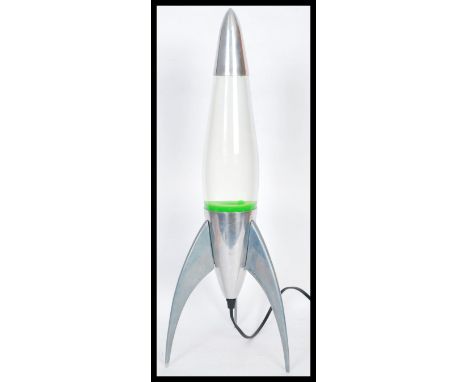 A vintage 20th Century retro Mathmos lava lamp in the form of an Atomic rocket, raised on three legs, the base being marked t
