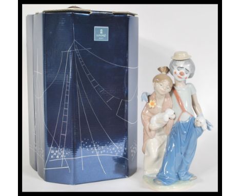 A Lladro ceramic figure depicting a clown and a boy entitled Forever Pals 07686. Complete in original box. Measures 24 cm hig