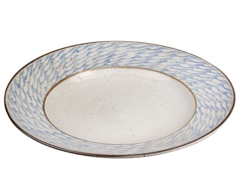 * Lloyd-Jones (David, 1928-1994). A large stoneware charger, covered in a speckled grey glaze with blue rim and repeated wax-