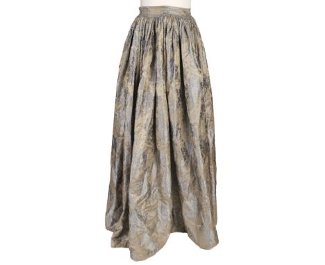 * Clothing. A blue brocade skirt, circa 1850s, hand-stitched close-gathered silk brocade skirt, with pattern of meandering ro
