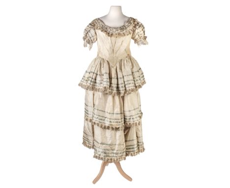 * Cothing. A mid 19th century silk bodice and matching skirt, hand-stitched, the cream silk fitted bodice with wide neckline,