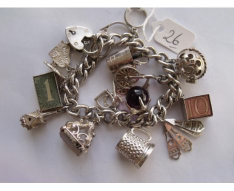 A vintage silver charm bracelet (74.8 grams).    