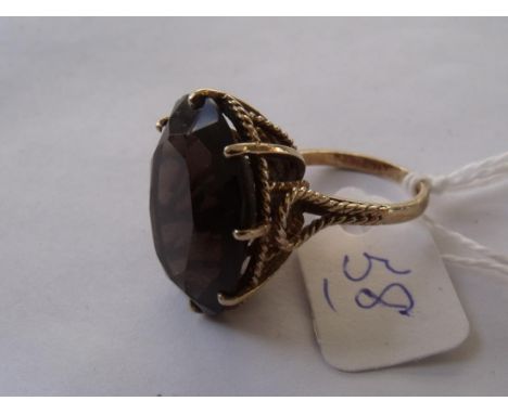 Large oval brown stone set ring in fancy  9ct mount approx size 'K'      