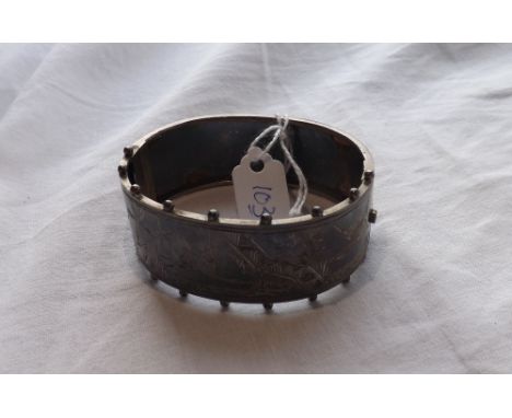 A hinged silver bangle depicting birds amongst  bamboo 27g        