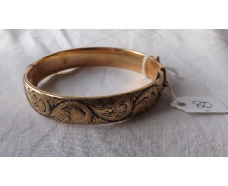 An embossed rolled gold bangle     