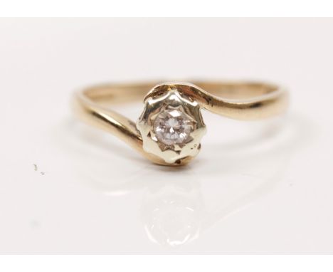 A hallmarked 9ct yellow gold diamond solitaire ring, set with a round brilliant cut diamond measuring approx. 0.10ct, in cros