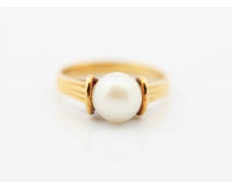 A pearl set ring, stamped 18ct, ring size L.