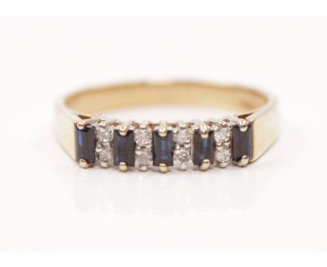 A hallmarked 9ct yellow gold sapphire and diamond ring, set with five baguette cut sapphires each separated by two single-cut