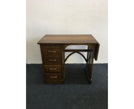 A small oak, four-drawer desk.