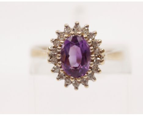 A hallmarked 9ct yellow gold amethyst and diamond cluster ring, ring size I