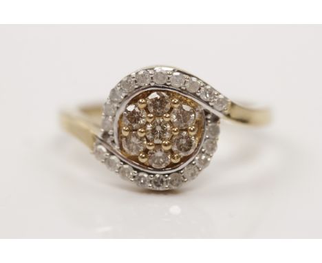 A hallmarked 9ct yellow gold diamond cluster ring, set centrally with seven champagne diamonds, surrounded by single cut colo