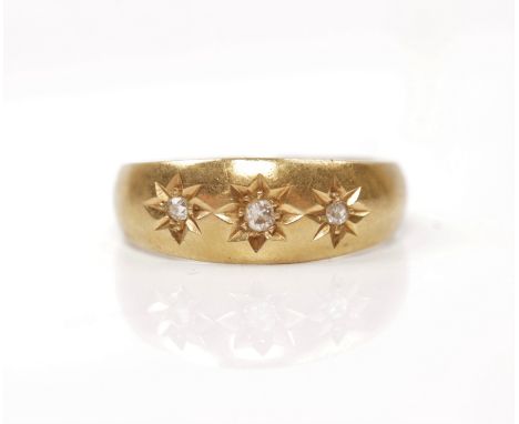 A hallmarked 18ct yellow gold diamond ring, star set with three graduated round cut diamonds, total diamond weight approx. 0.