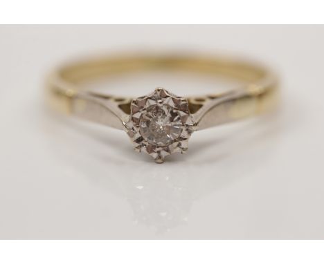A diamond solitaire ring, illusion set with a round brilliant cut diamond measuring approx. 0.10ct, stamped 18ct, ring size L