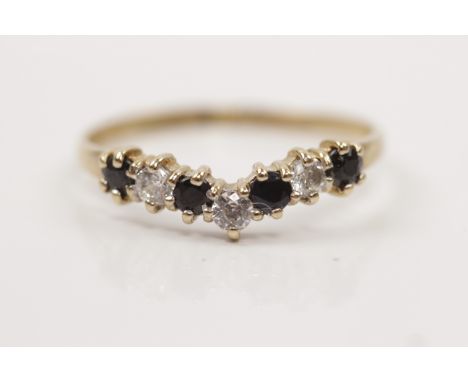 A hallmarked 9ct yellow gold sapphire and cubic zirconia chevron design ring, ring size P