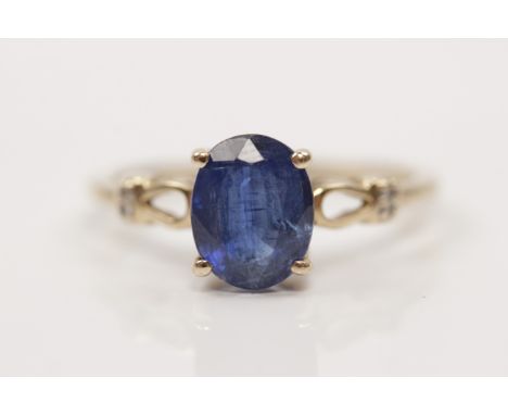 A hallmarked 9ct yellow gold sapphire and diamond ring, set with a central sapphire (possibly treated) to open metalwork shou