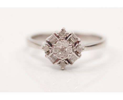 A diamond cluster ring, set with round brilliant and baguette cut diamonds in flower head design, hallmark rubbed (reads 375)