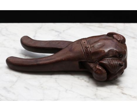 Nutcrackers - a Black Forest novelty lever-action nut cracker, carved as the head of a bulldog, glass eyes, 21cm long, early 