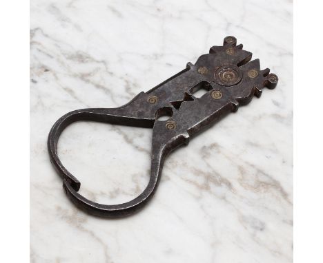 Nutcrackers - a 19th century Spanish iron lever-action nut cracker, shaped jaws, decorated with brass roundels, 11.5cm longRe