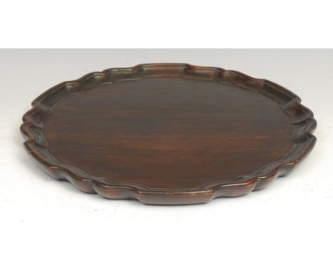 A 19th century mahogany waiter, in the Chippendale taste, pie crust border, 28cm diam 