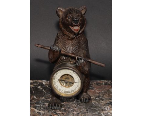 An early 20th century Black Forest carving, of a bear, holding an aneroid barometer, 21cm high 