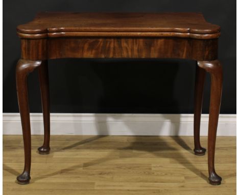 A George II mahogany concertina-action card table, hipped rectangular top enclosing a baize lined playing surface and counter