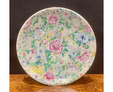 A Chinese circular charger, painted in the famille rose palette with layered flowers, 33.5cm diam, red seal mark 