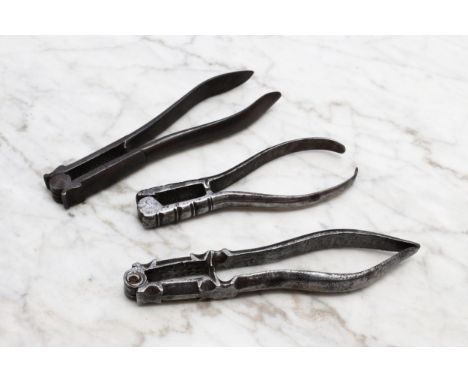Nutcrackers - an 18th century steel lever-action nut cracker, 13.5cm long, c.1740; others, similar (3) 