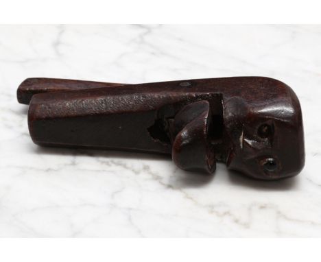 Nutcrackers - a 19th century novelty lever-action nut cracker, naively carved as a face, 14cm long 
