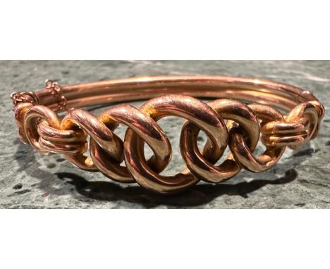 A gold coloured metal hollow cast hinged bangle, five interlinked graduated curb links, stamped '9ct' for 9ct gold, 5.8cm int