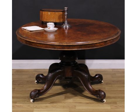 A Victorian walnut centre table, quarter-veneered oval tilting top, turned column, cabriole legs, ceramic casters, 69cm high,